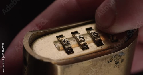 Loop of Person spins combination lock, close up. Loop 1 of 2.