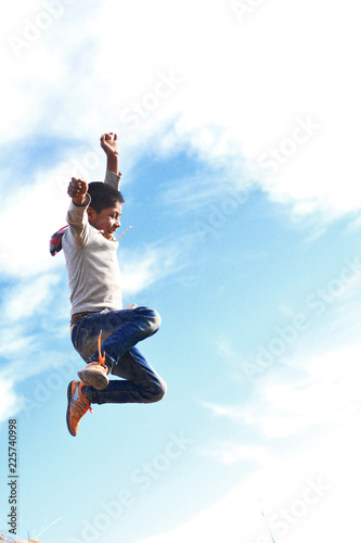 Excited native american boy jumping very high.