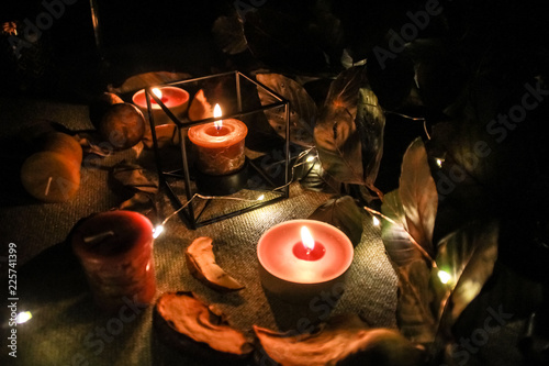 Night Helloween composition with dried apple and candles.Warm and cold light.Garland.Autumn comfort.