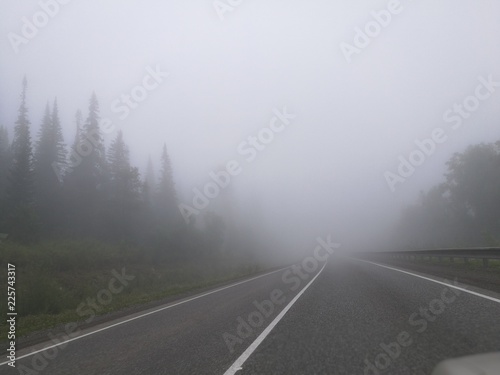 road highway sky landscape asphalt fog