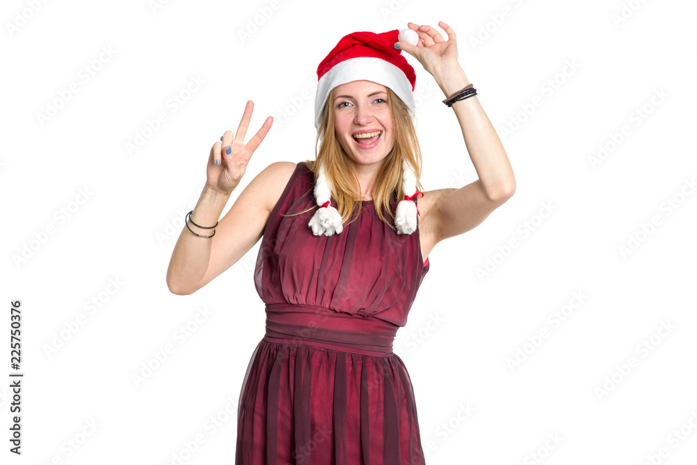 Cheerful young woman in Santa Claus hat is showing two fingers up, V sign. Christmas, New Year's mood. Cheerful young woman in Santa Claus hat is showing two fingers up, V sign. Christmas, New Year's mood.