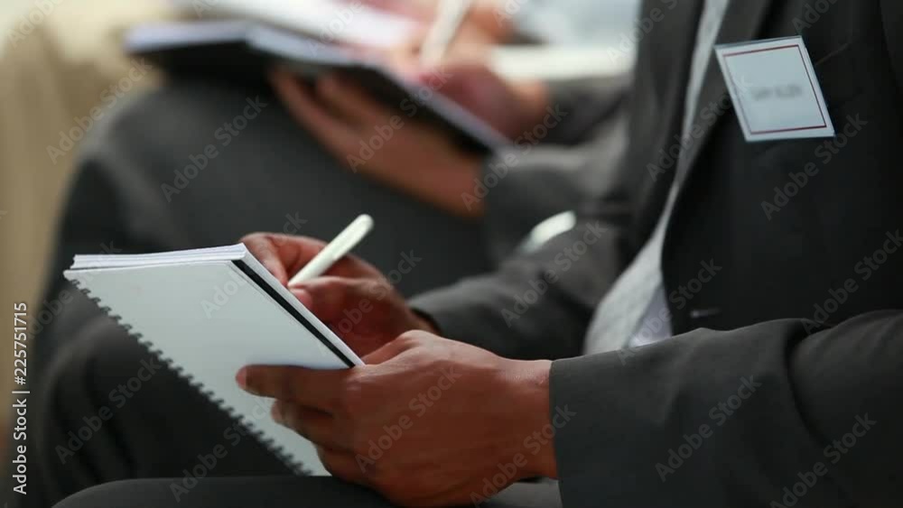 Loop of Business people writing on notepads