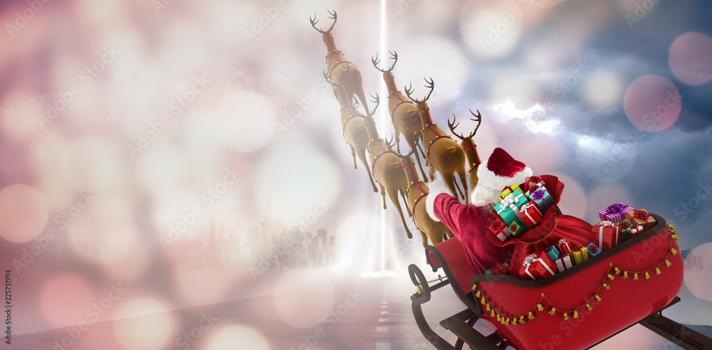 Composite image of high angle view of santa claus riding on sled
