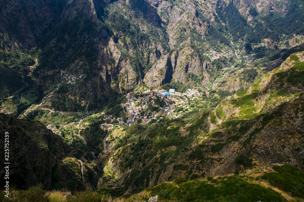 The village of Curral das Freiras( Valley of the Nuns) on Madeira island, Portugal. Areal view, shot from viewpoint on the mountain. Lies in steep valley between high mountains.