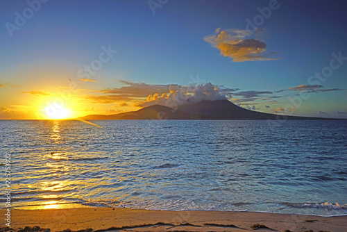 Fototapeta Naklejka Na Ścianę i Meble -  Night view of the Nevis Peak volcano across the Caribbean Sea from St Kitts