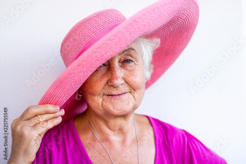Charming grandmother in a hat with blue eyes