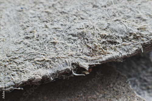 Detailed photography of roof covering material with asbestos fibres. Health harmful and hazards effects. Prolonged inhalation of microscopical fibers causes fatal illnesses including lung cancer.	