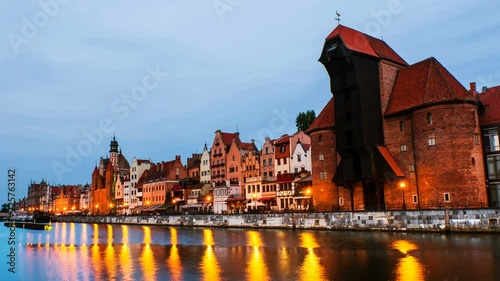 Gdansk, Poland. A sunset time-lapse on 
a cloudy summer morning in the old town of Gdansk, Poland, with boats moored to the enbankment and Brama Żuraw. Zoom in photo