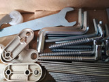 Ironmongery silver bronze iron stainless steel wrench tapping screw repair cardboard background macro photo