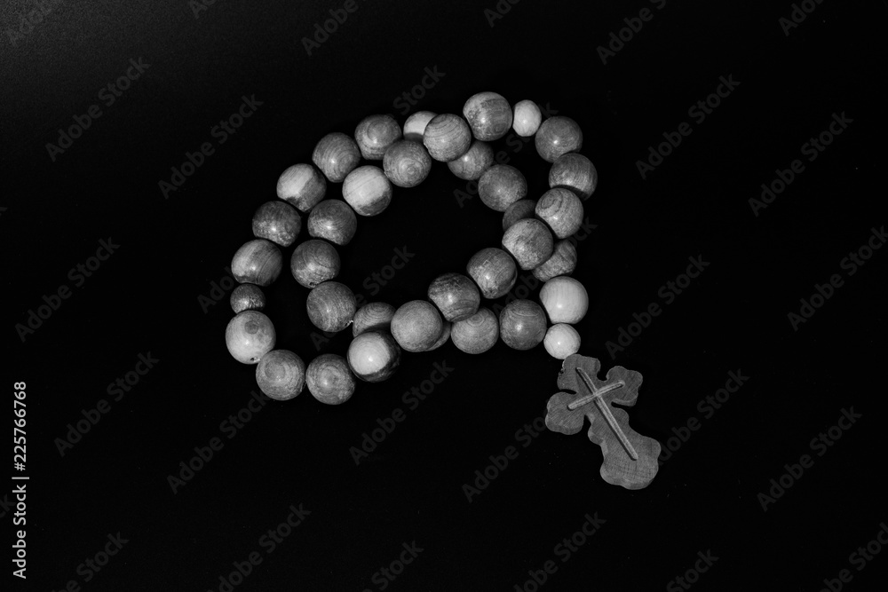 Rosary with a cross on a black background