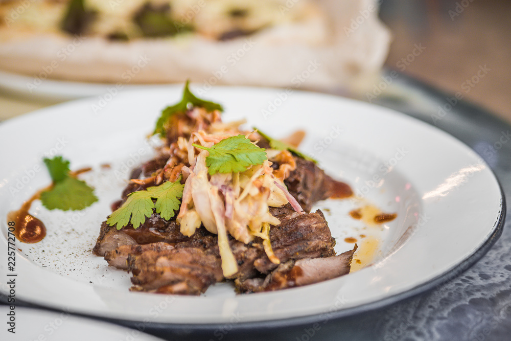 Vkusnoe, delicious hot dish of meat with vegetables and spices Vkusnoe, delicious hot dish of meat with vegetables and spices