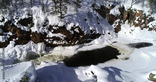 Lapland rapids, C4K aerial rising drone view of kiutakongas rapid, in Oulanka national park, on a sunny, winter day, in Kuusamo, Pohjois-Pohjanmaa, Finland