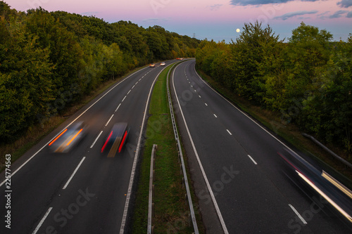 British dual carriageway road during sunset with rising full moon in the background photo