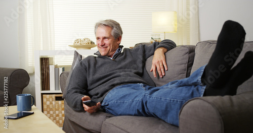 Photography Relaxed senior male lying on a couch