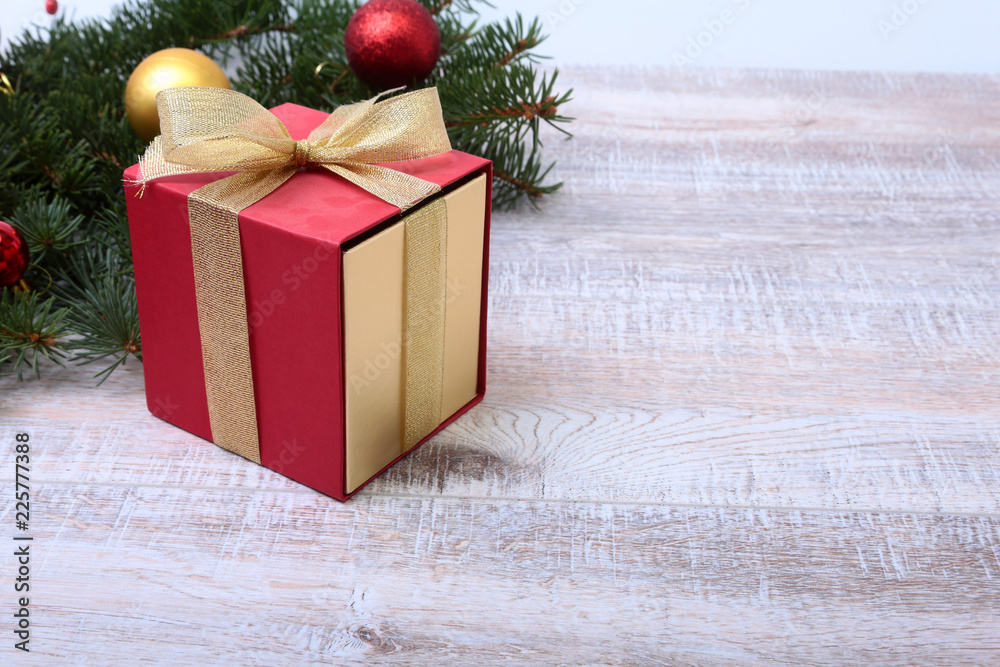 Christmas fir tree with gift box on wooden board Christmas fir tree with gift box on wooden board