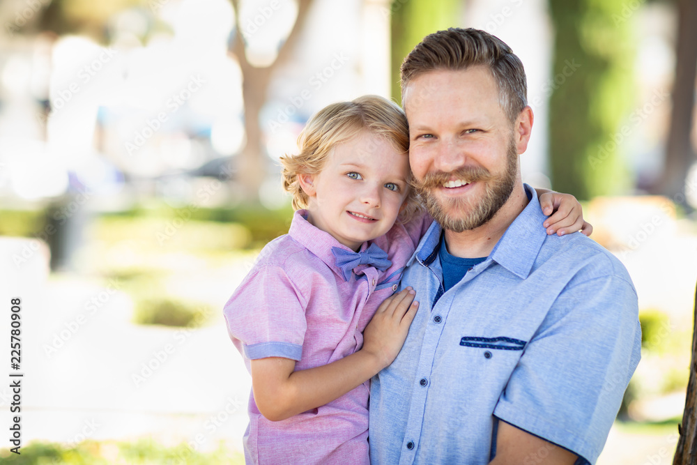 Young Caucasian Father And Son Portrait At The Park Young Caucasian Father And Son Portrait At The Park