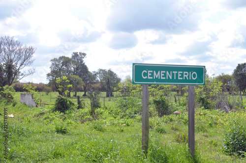 Oxide metal cross into an abandoned cemetery of Black People in the Jewish cementary of the rural village Ingeniero Sajaroff in Entre Rios Province, Argentina photo