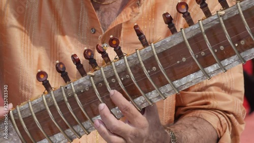 Hands of Indian musician playing Sitar shot in slow motion 180 fps. photo