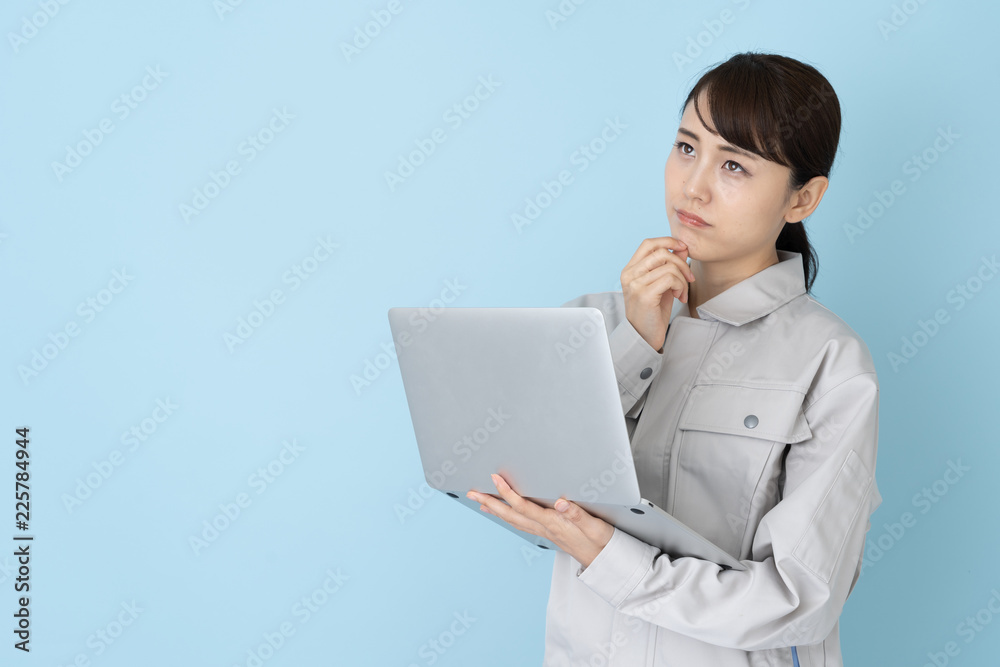 portrait of asian engineer woman on blue background portrait of asian engineer woman on blue background