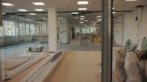 The office is in repair white walls light burning building materials builder building construction contractor engineer industrial male renovation technician development design project slow motion
