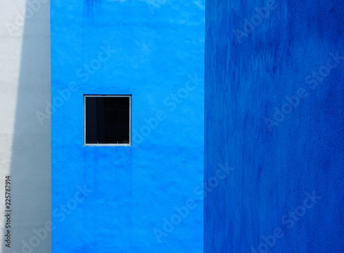 Small window on a blue building. © arfa_adam