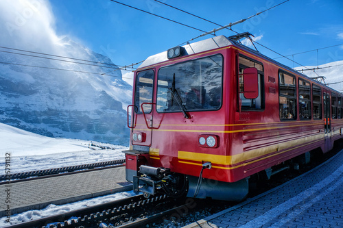 A red Swiss train at a station in Switzerland
