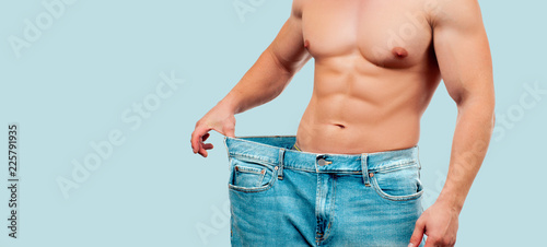 Foto Man wearing big jeans after diet, weight loss