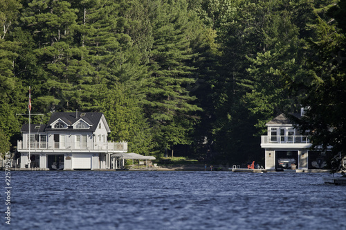 Slika na platnu Cottage and a boathouse