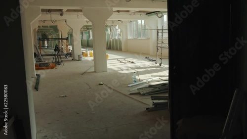 The office is in repair white walls light burning building materials builder building construction contractor engineer industrial male renovation technician development design project slow motion