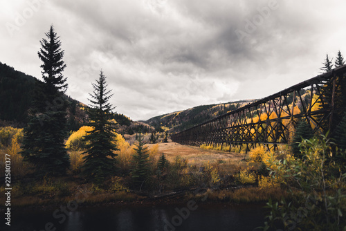 A wooded structure running through an autumn mountain landscape.  photo