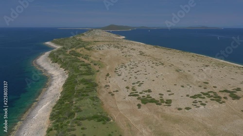 Aerial - Flyover stretching island surrounded with seawater photo