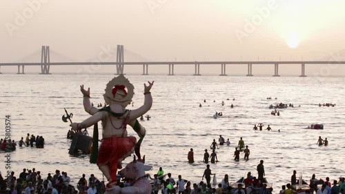 Ganesh idol carried to the sea water at the beach for immersion. Last day of the Ganesh Festival celebration in Mumbai, India.