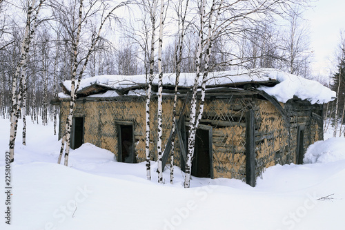 Abandoned Soviet prison in winter in the snow and birch trees in Northern Siberia