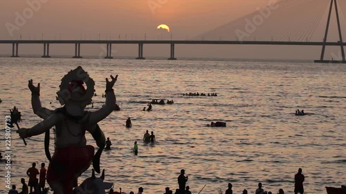 Ganesh idol carried to the sea water at the beach for immersion. Last day of the Ganesh Festival celebration in Mumbai, India.