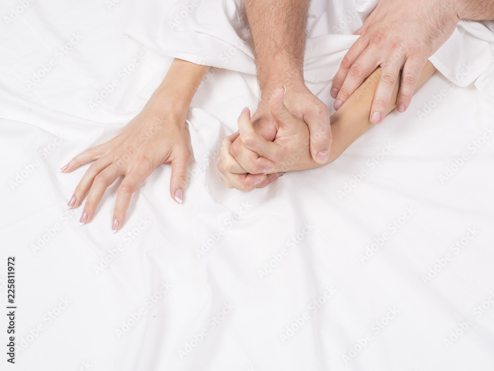 couple hands pulling white sheets in ecstasy, orgasm. Concept of passion. Orgasm. Erotic moments. Intimate concept. Sex couple. Bedroom couple hands pulling white sheets in ecstasy, orgasm. Concept of passion. Orgasm. Erotic moments. Intimate concept. Sex couple. Bedroom