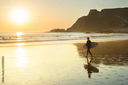 woman surfboard walking bea...