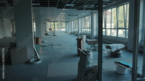 The office is in repair white walls light burning building materials builder building construction contractor engineer industrial male renovation technician development design project slow motion