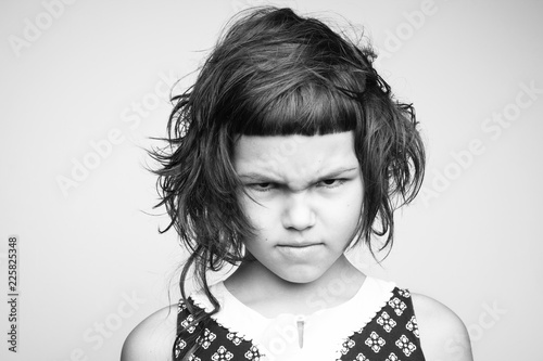Little angry girl with stylish haircut