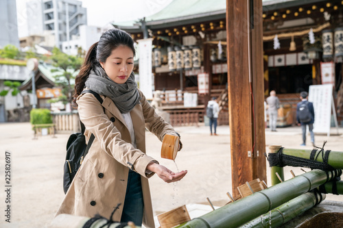 female tourist washing hands in the temple photo