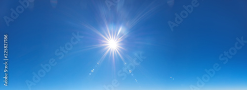 sky background with sun beams on bright blue sky