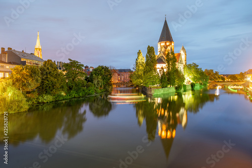 Night view on the riverside with basilica in Metz city, France