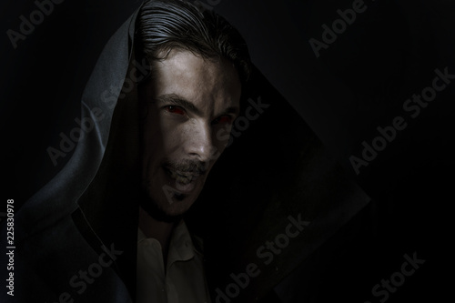 Scary Vampire in the hood with Red eyes full of blood