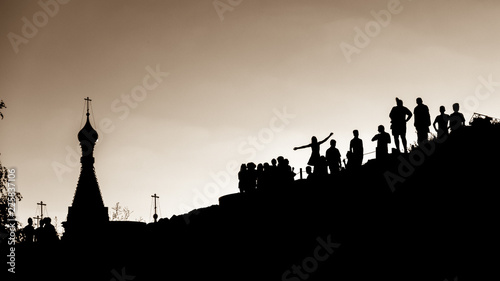 The contours of the people and the church in the park Zaryadye, in Moscow at sunset