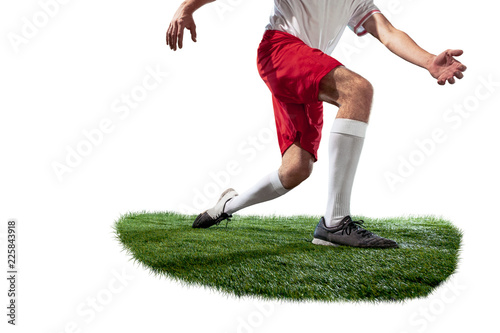 Football playe tackling for the ball over white background. Professional football soccer players in motion on green grass studio background. legs closeup photo