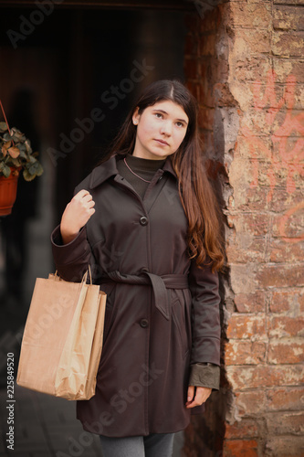 girl with long brown hair street photo walk on grafiti wall background photo