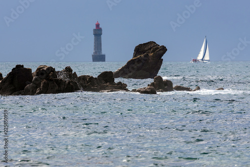 La Jument lighthouse and sailboat photo