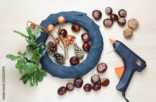 Chestnuts and autumn decorations on a wooden background. photo