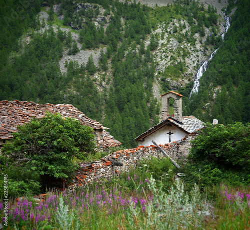 alpine old church and mountain waterfall at background, Rhemes, Notre Dame photo