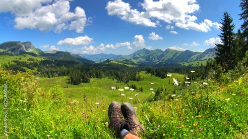 Summer time mountain nature panoramic landscape near Habkern, Switzerland. Hikers trekking boots at foreground