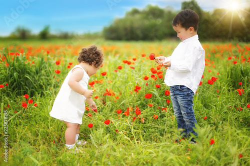 kazakh little boy and girl together playing in the summer park photo